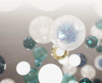Close-up view of the Lasvit chandelier at Serenia Living, showing hand-blown glass spheres in white, turquoise and deep blue tones.