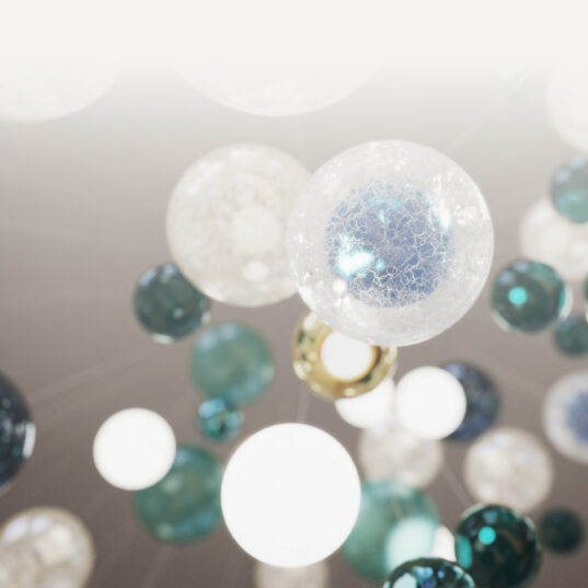 Close-up view of the Lasvit chandelier at Serenia Living, showing hand-blown glass spheres in white, turquoise and deep blue tones.